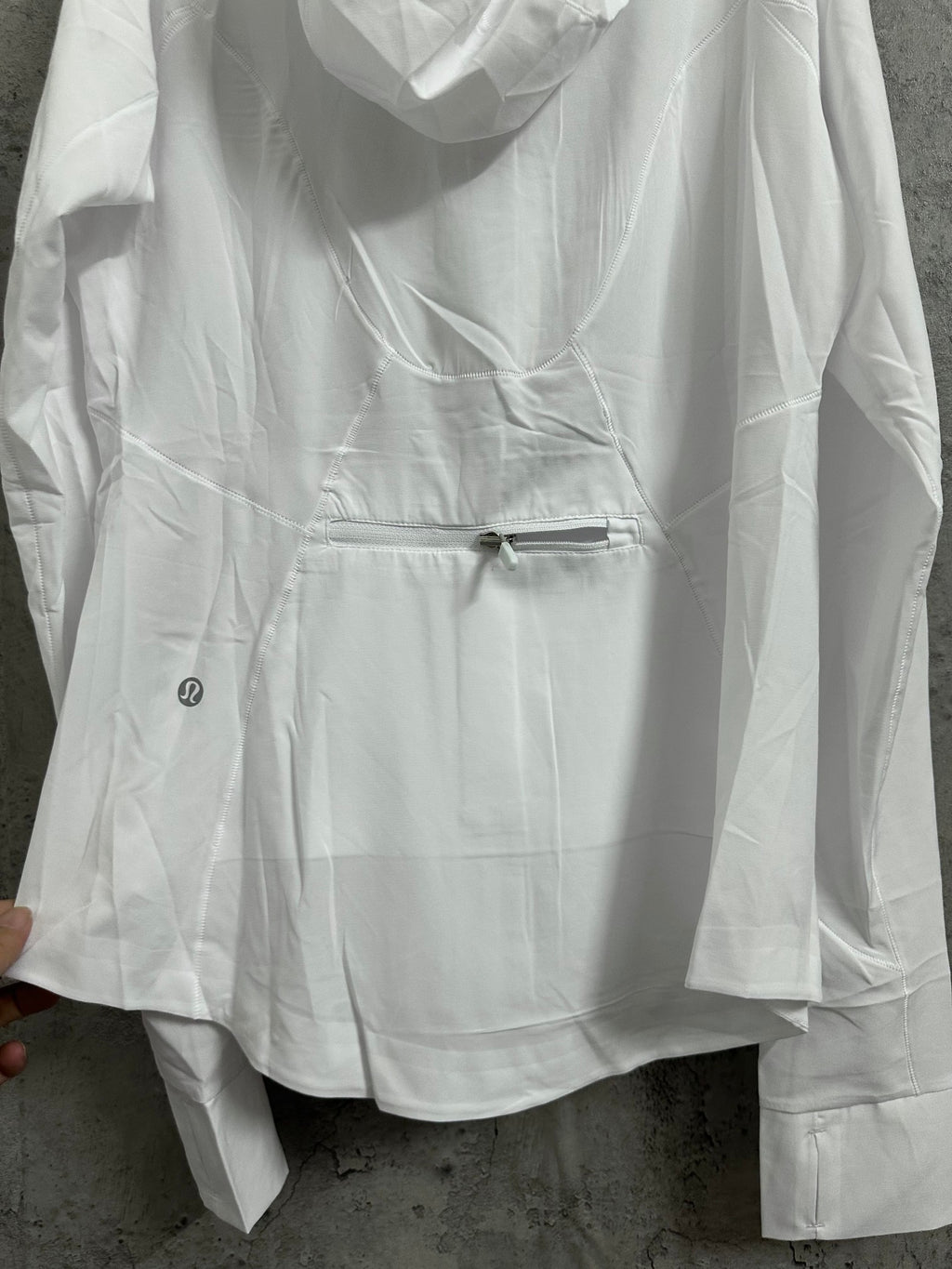 White hooded jacket front with drawstring waist and zipper closure
