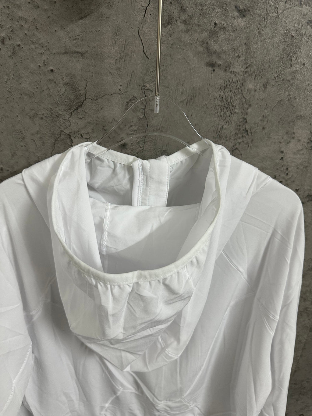 White hooded jacket neckline with draped hood and long sleeves