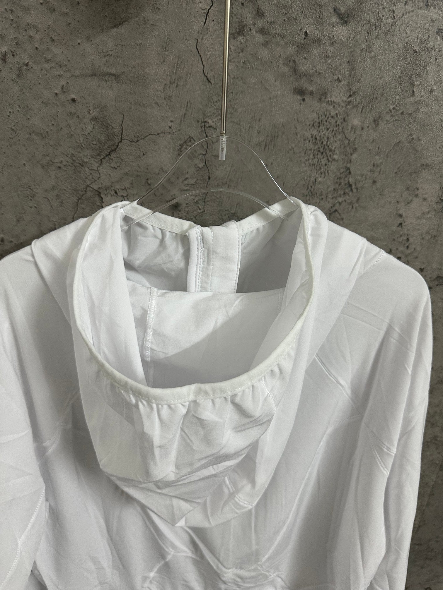 White hooded jacket back view with scoop hood and seam lines