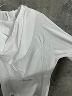 White hooded jacket with gathered shoulder and pleated front panel
