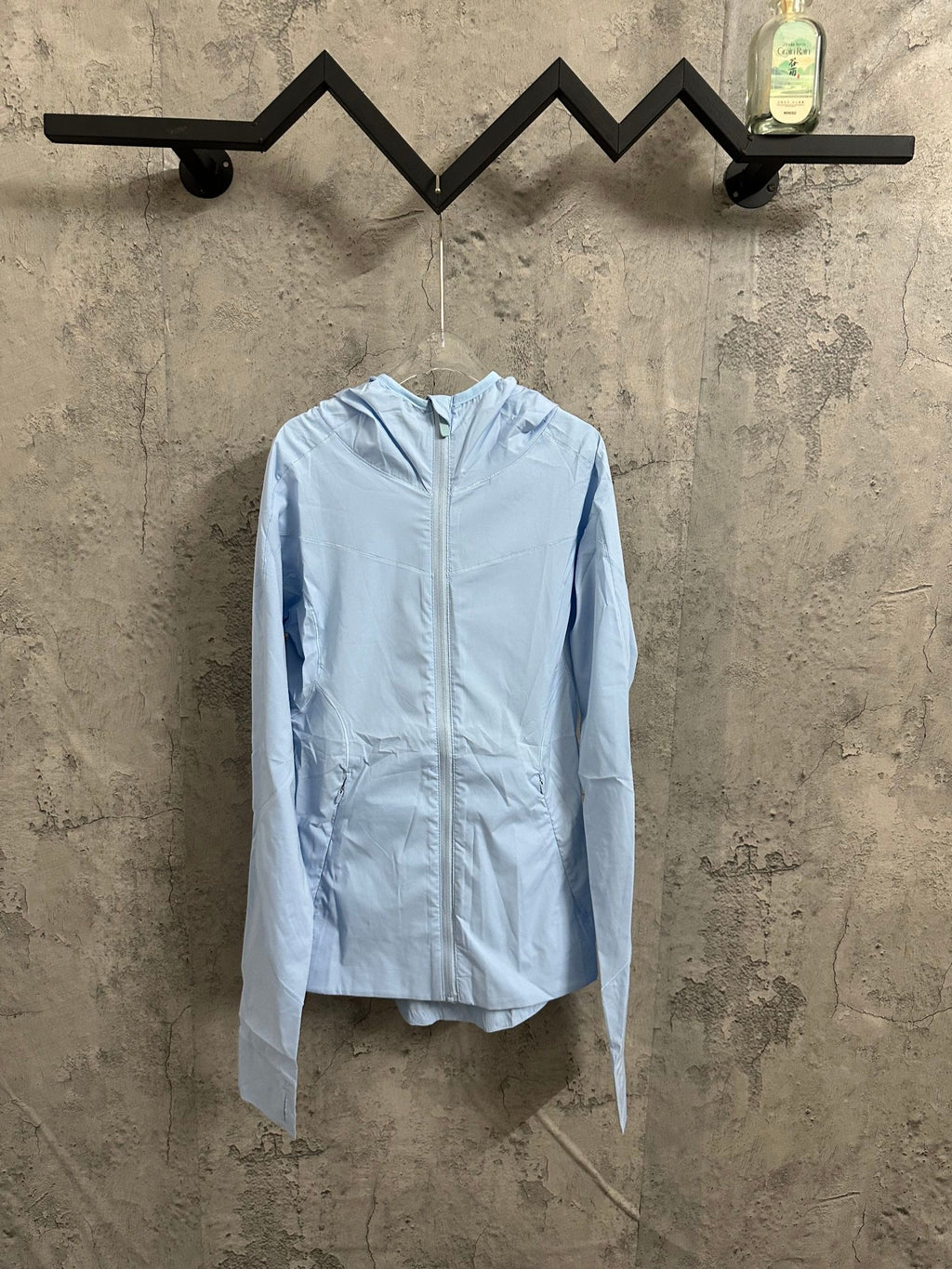 Light blue hooded windbreaker jacket with full-length zipper