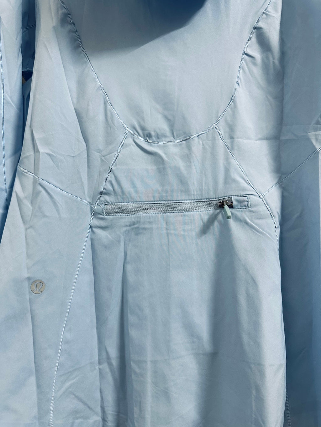 Light blue hooded windbreaker jacket with front zip pocket