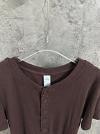 Brown henley T-shirt neckline with three-button placket and ribbed collar