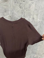 Brown henley T-shirt back close-up with crew neck and ribbed texture