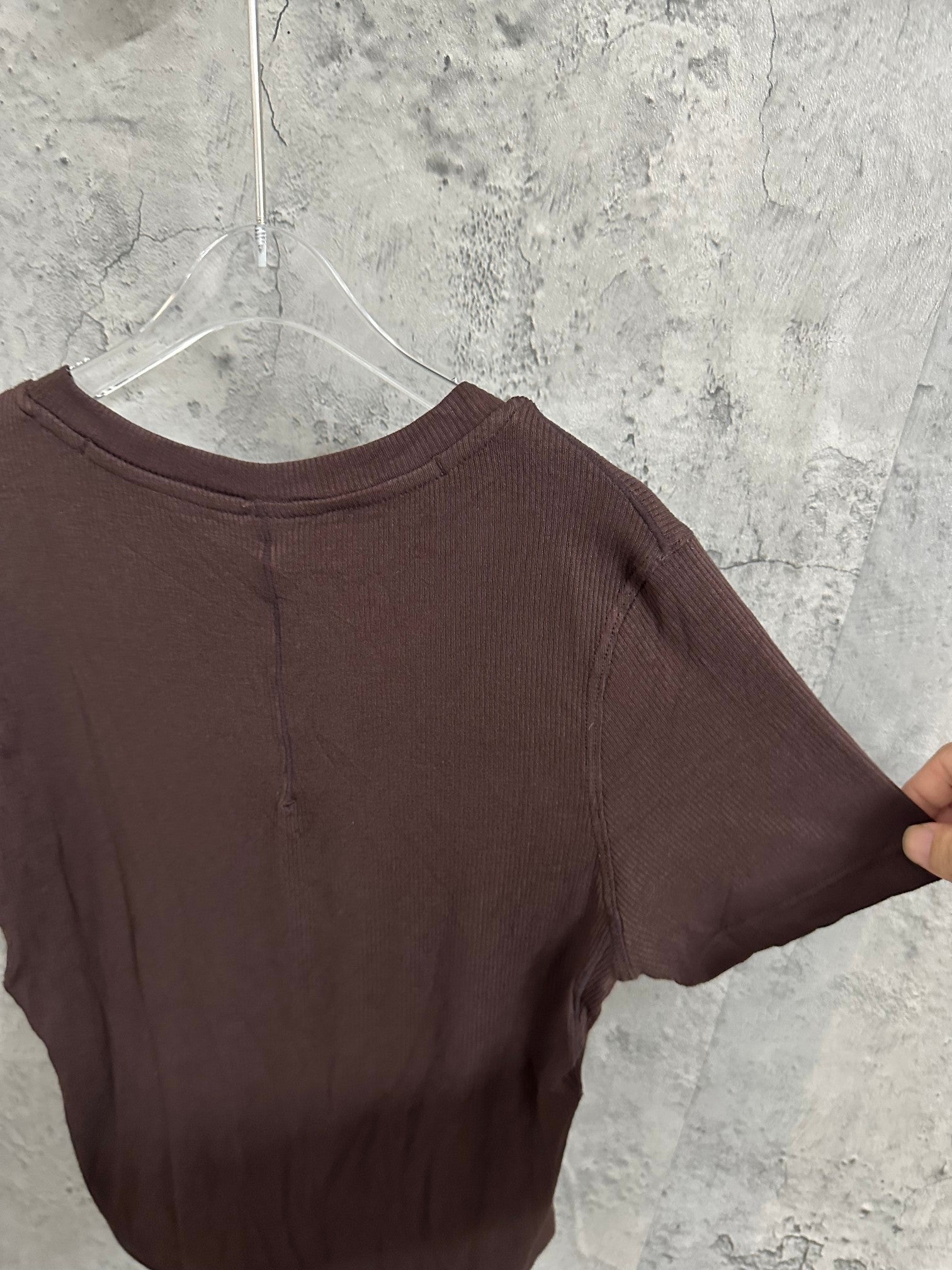 Brown henley T-shirt back close-up with crew neck and ribbed texture