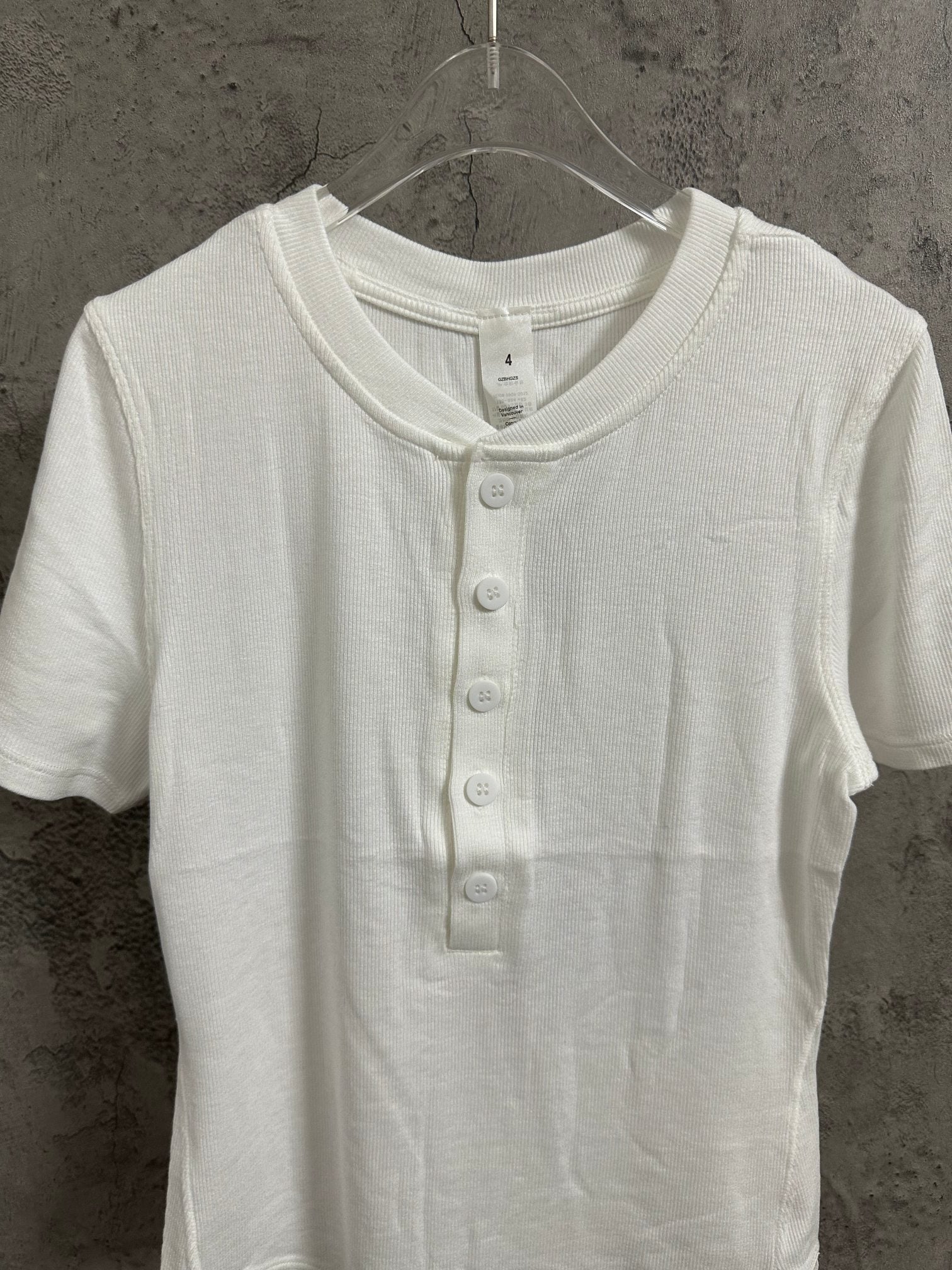 White short-sleeve henley shirt with buttoned crew neckline