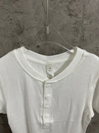 White henley T-shirt neckline close-up with button placket detail