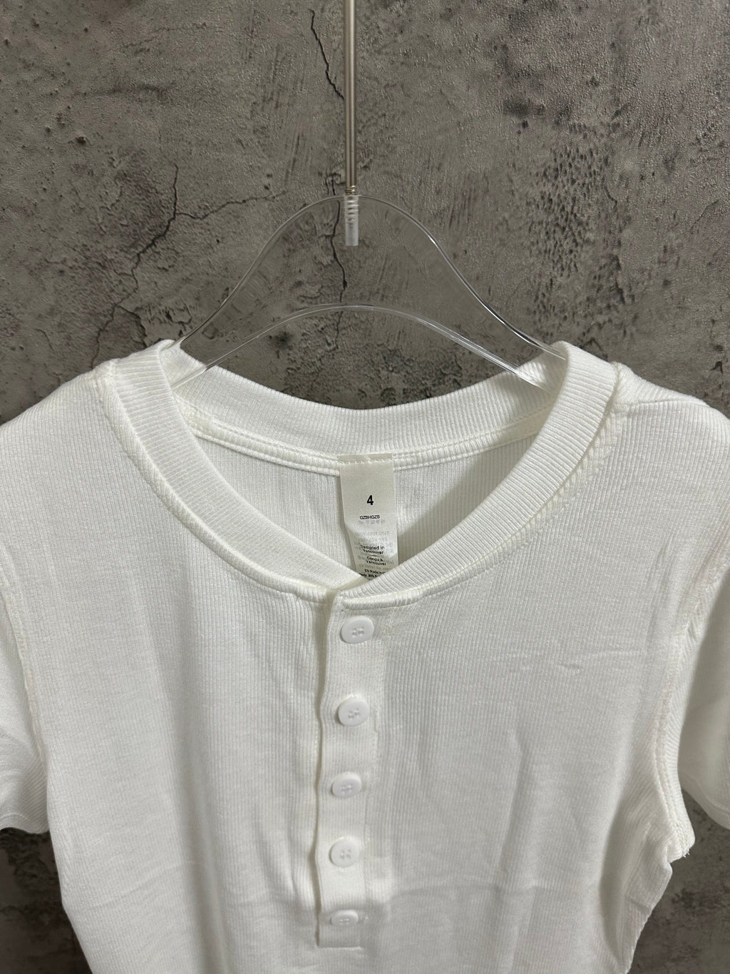 White henley shirt neckline with buttoned placket and short sleeves