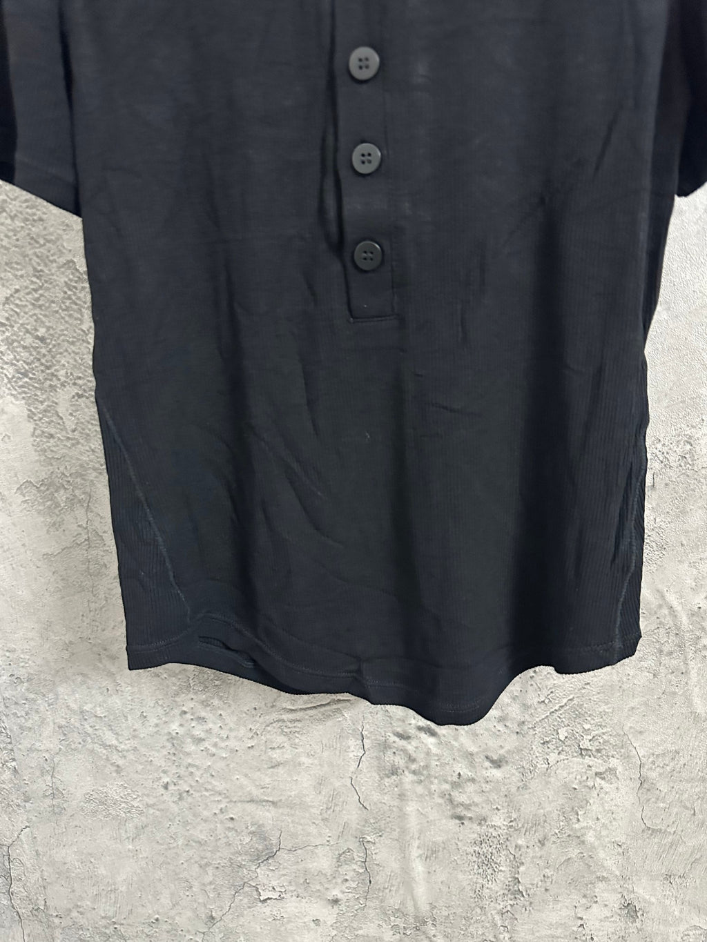 Dark henley shirt front with button placket and rounded neckline