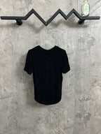 Back of short-sleeve henley shirt in dark knit fabric with ribbed crew neckline.