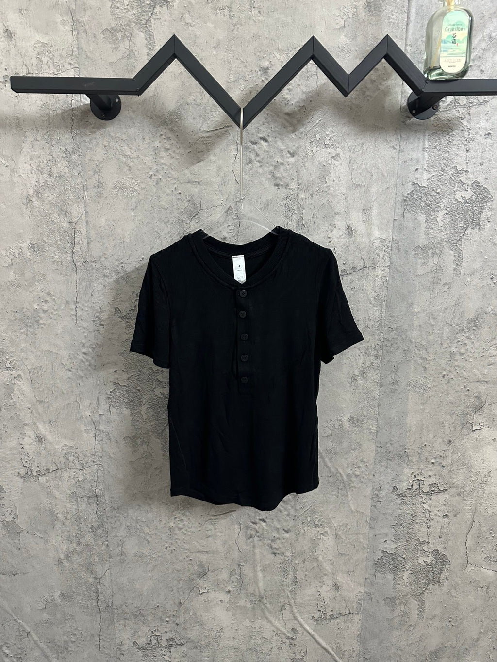 Dark henley shirt with short sleeves and button placket at the front