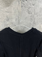 Upper back of short-sleeve henley shirt in dark knit with ribbed crew neckline.
