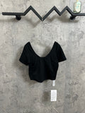 Women’s dark athletic crop top with scoop neckline and short sleeves