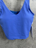 Blue ribbed tank top close-up: scoop back neckline and wide hem