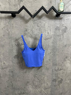 Blue ribbed tank top with scoop neckline and thin spaghetti straps