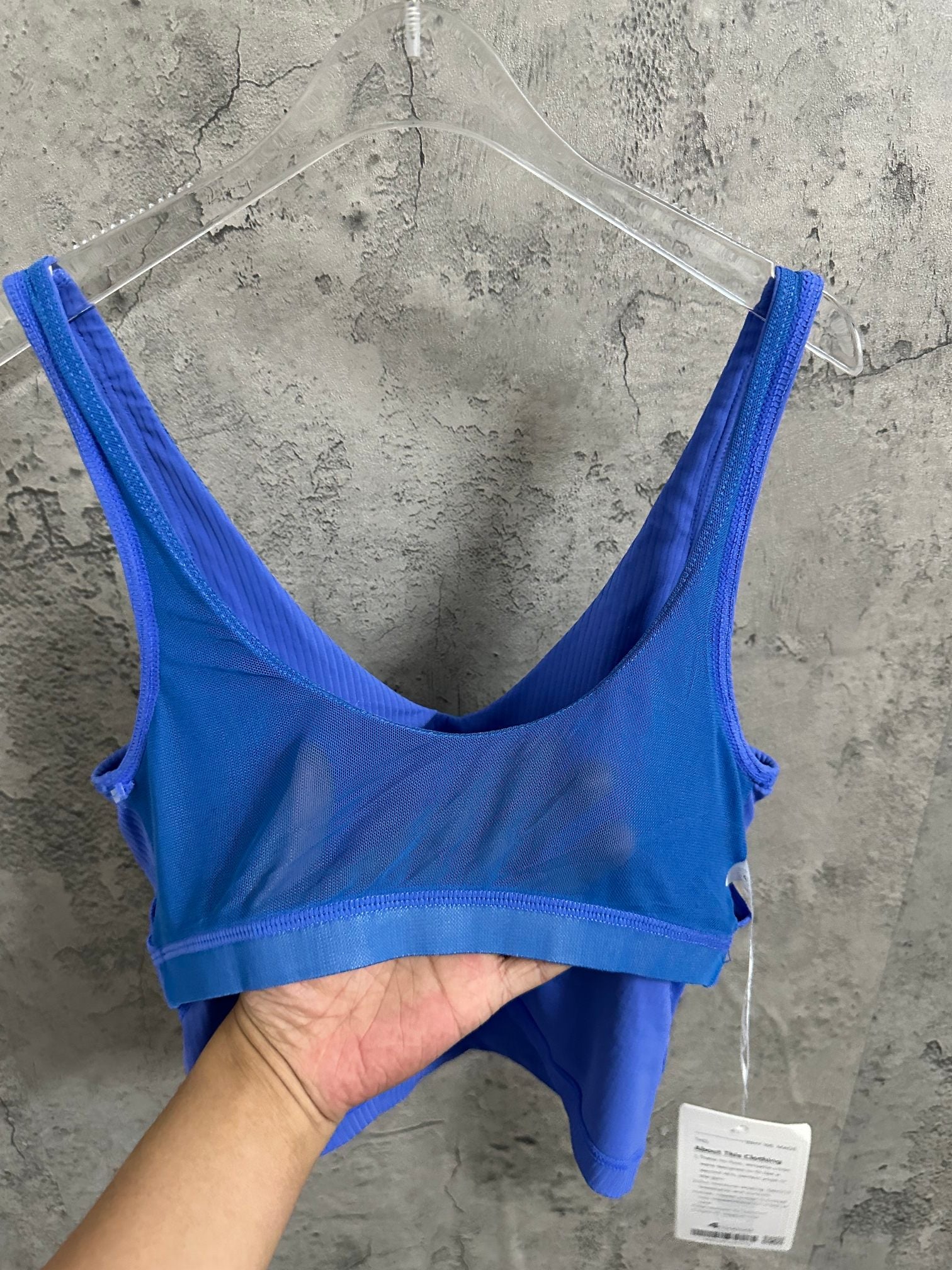 Blue ribbed tank top on hanger, scoop back and thin straps