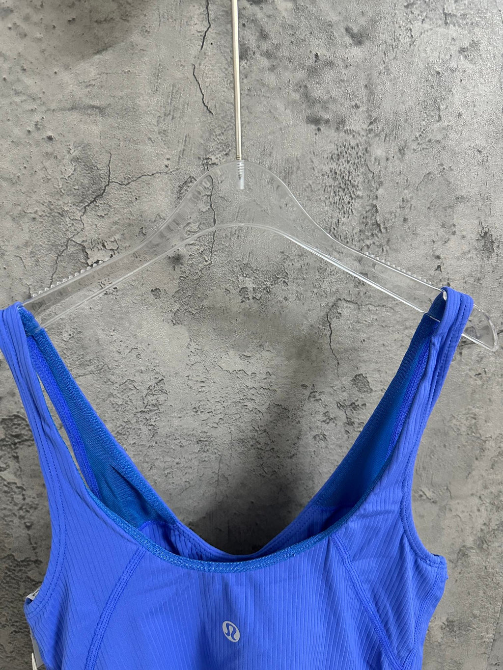 Blue ribbed tank top close-up, scoop back neckline and thin straps