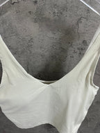 Light cream ribbed camisole with wide V-neck and thin shoulder straps