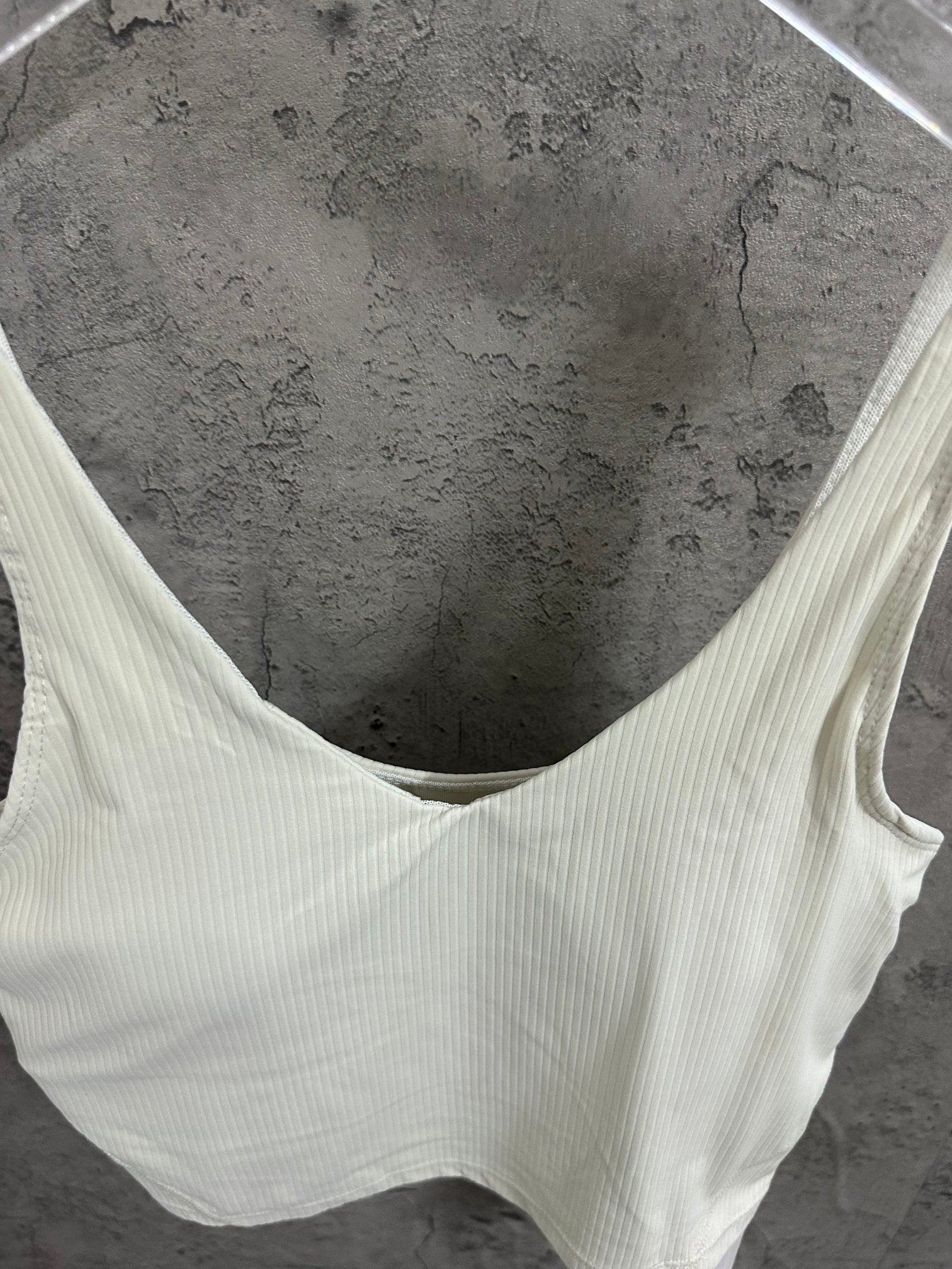 Light cream ribbed camisole with wide V-neck and thin shoulder straps