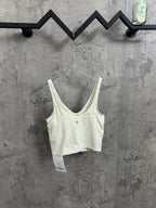 Light cream camisole tank with V-neck, spaghetti straps, and snap at bust