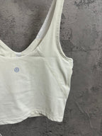 Light cream ribbed camisole with V-neckline and small chest logo