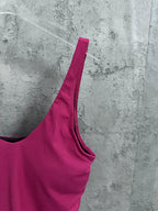 Pink camisole side view with spaghetti strap and black-trim neckline