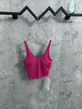 Pink ribbed camisole with spaghetti straps and scoop neck, black trim