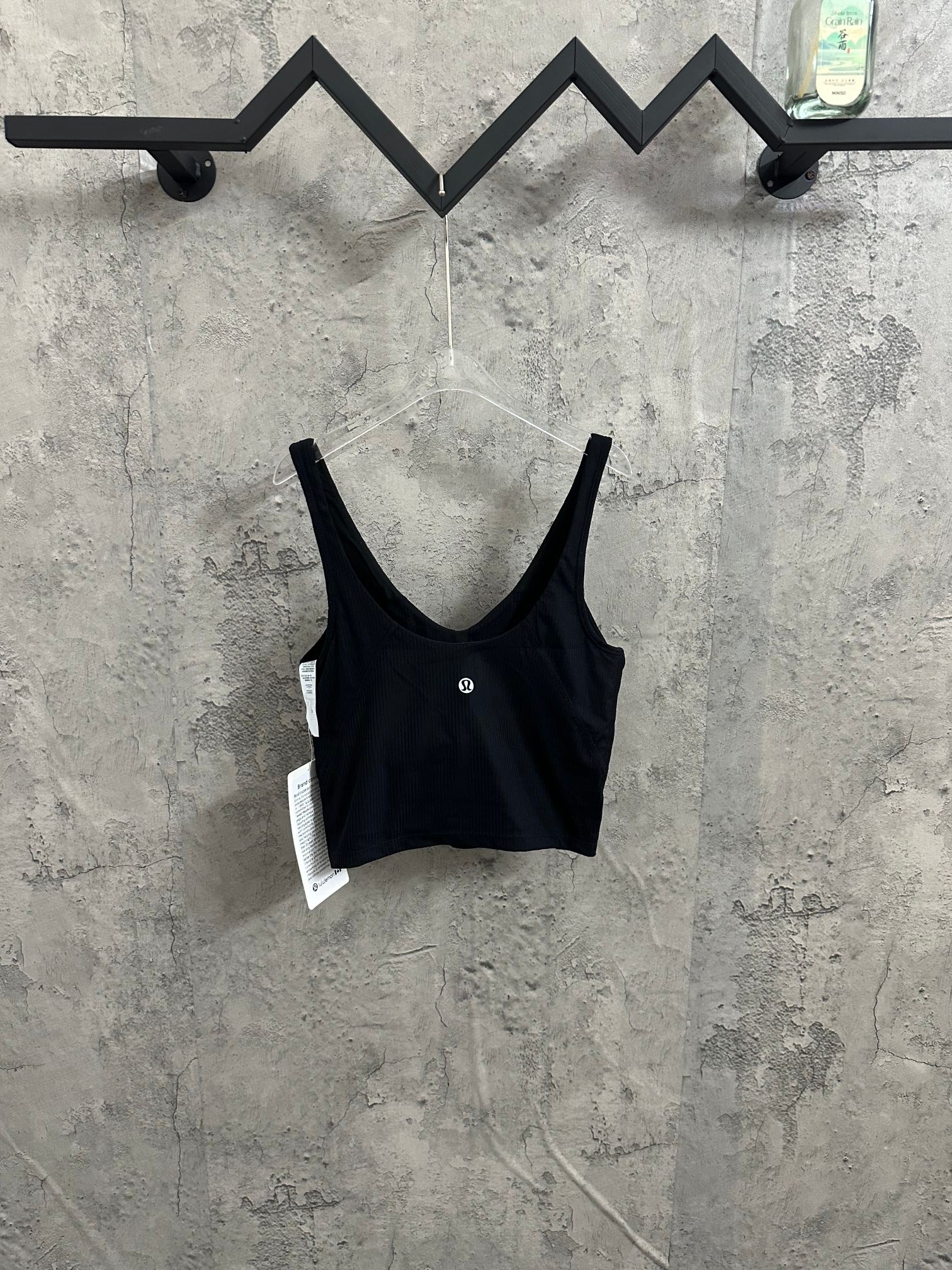 Black ribbed sports bra with scoop neck and adjustable-looking straps