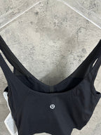 Black ribbed sports bra back view with small chest logo patch