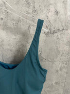 Teal tank top with wide strap, scoop neckline, and elastic hem