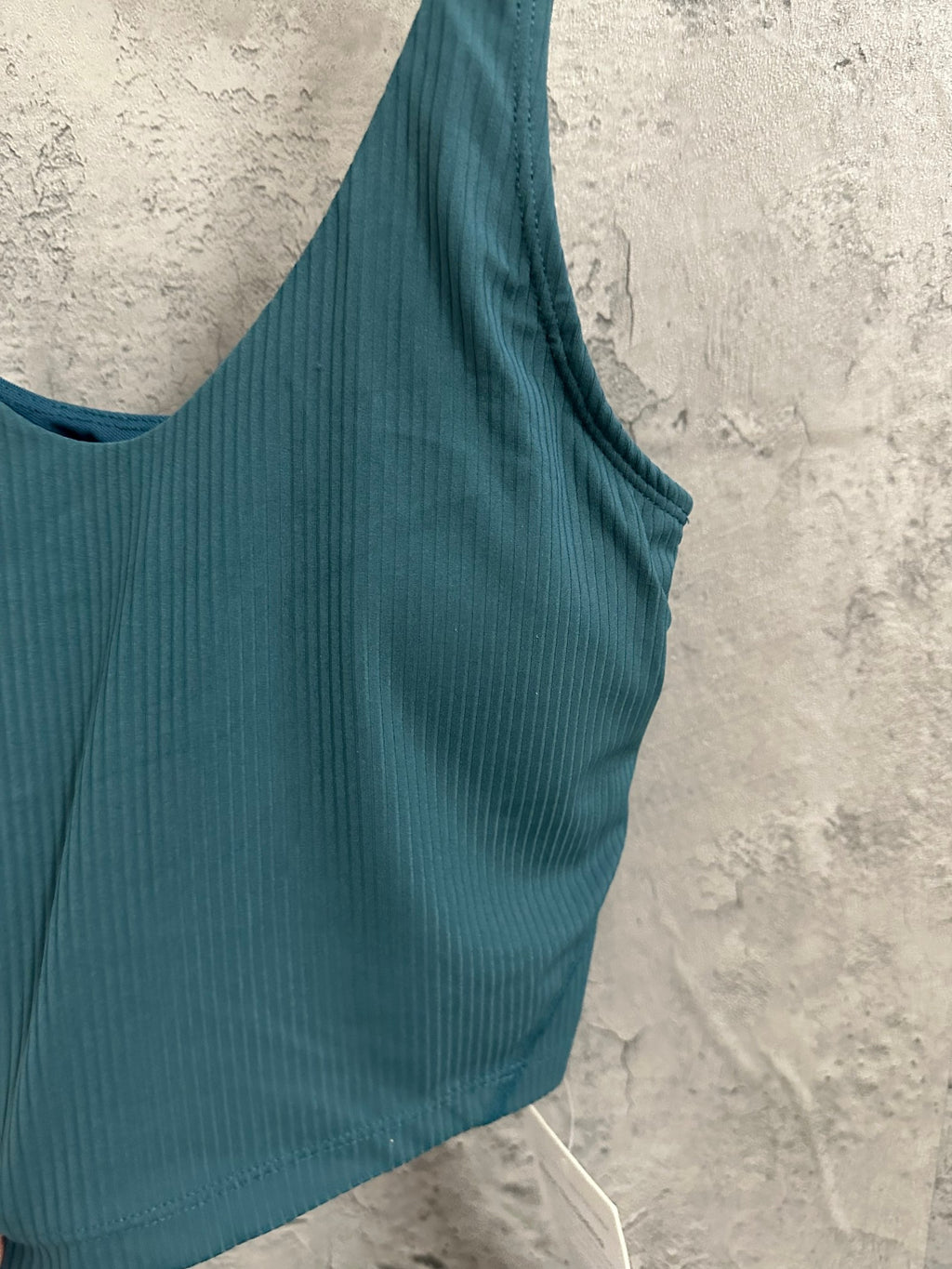 Teal ribbed camisole tank with wide straps and curved hem
