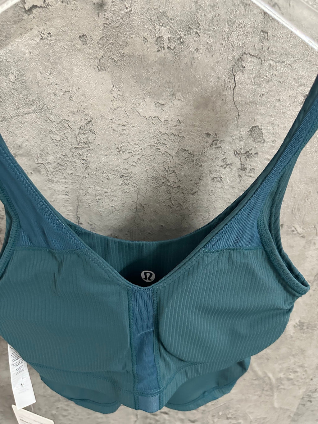 Teal ribbed tank top with V-scoop back opening and wide straps
