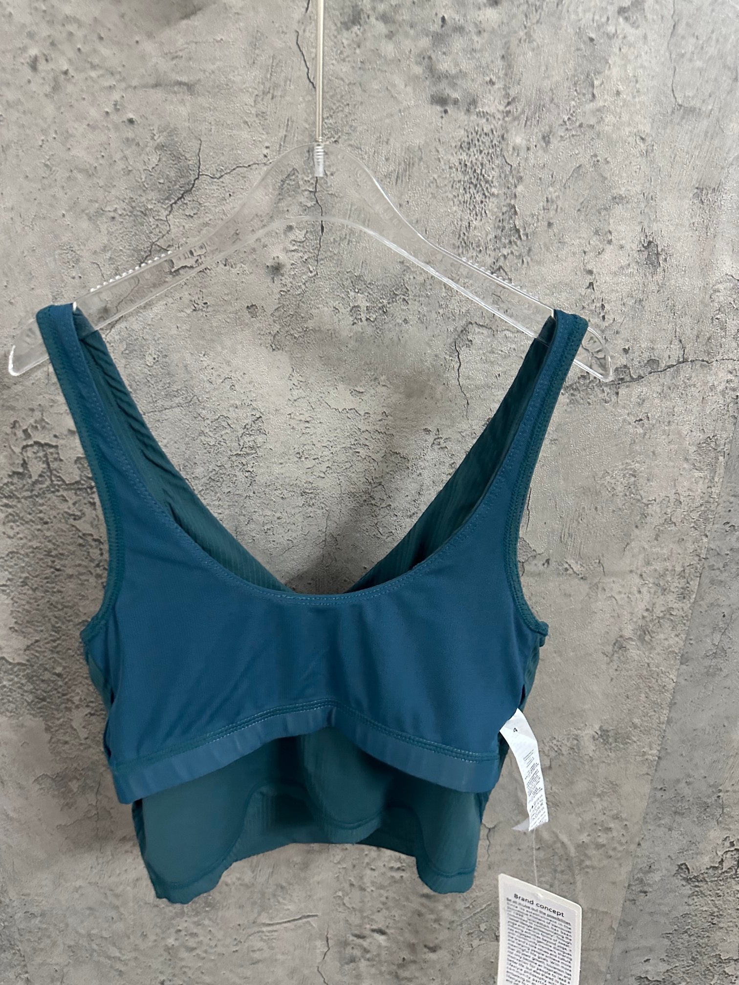 Teal ribbed tank top with wide straps, scoop front, and attached tags