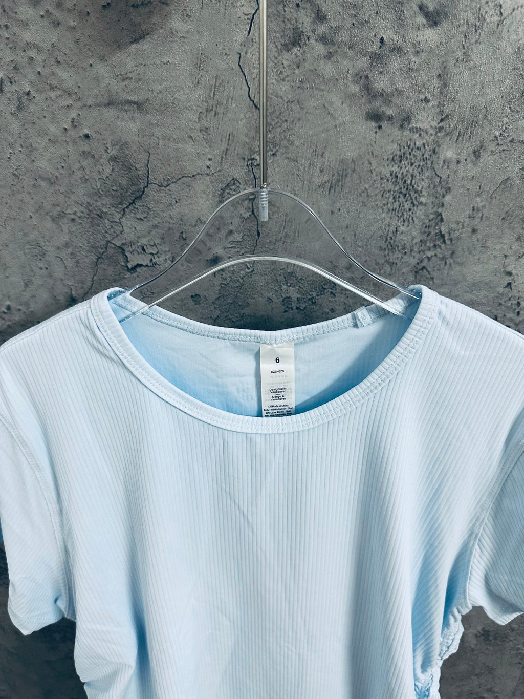 Light blue ribbed T-shirt neckline with inner tag at center