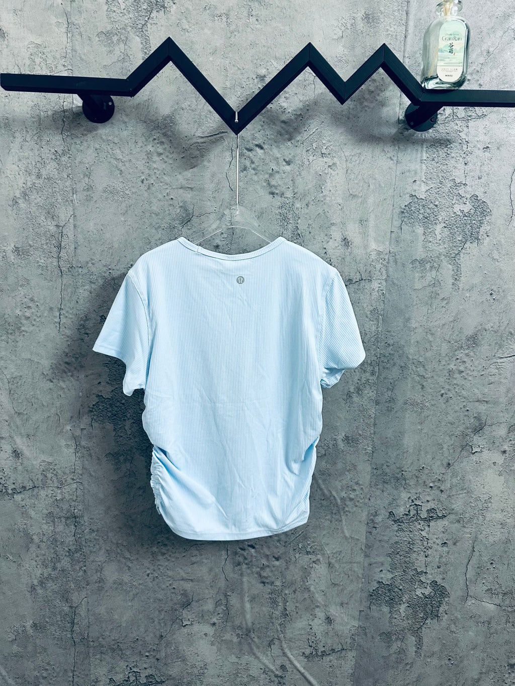 Light blue T-shirt on hanger, crew neck and short sleeves