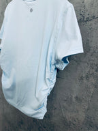 Light blue T-shirt back view with short sleeves and curved hem
