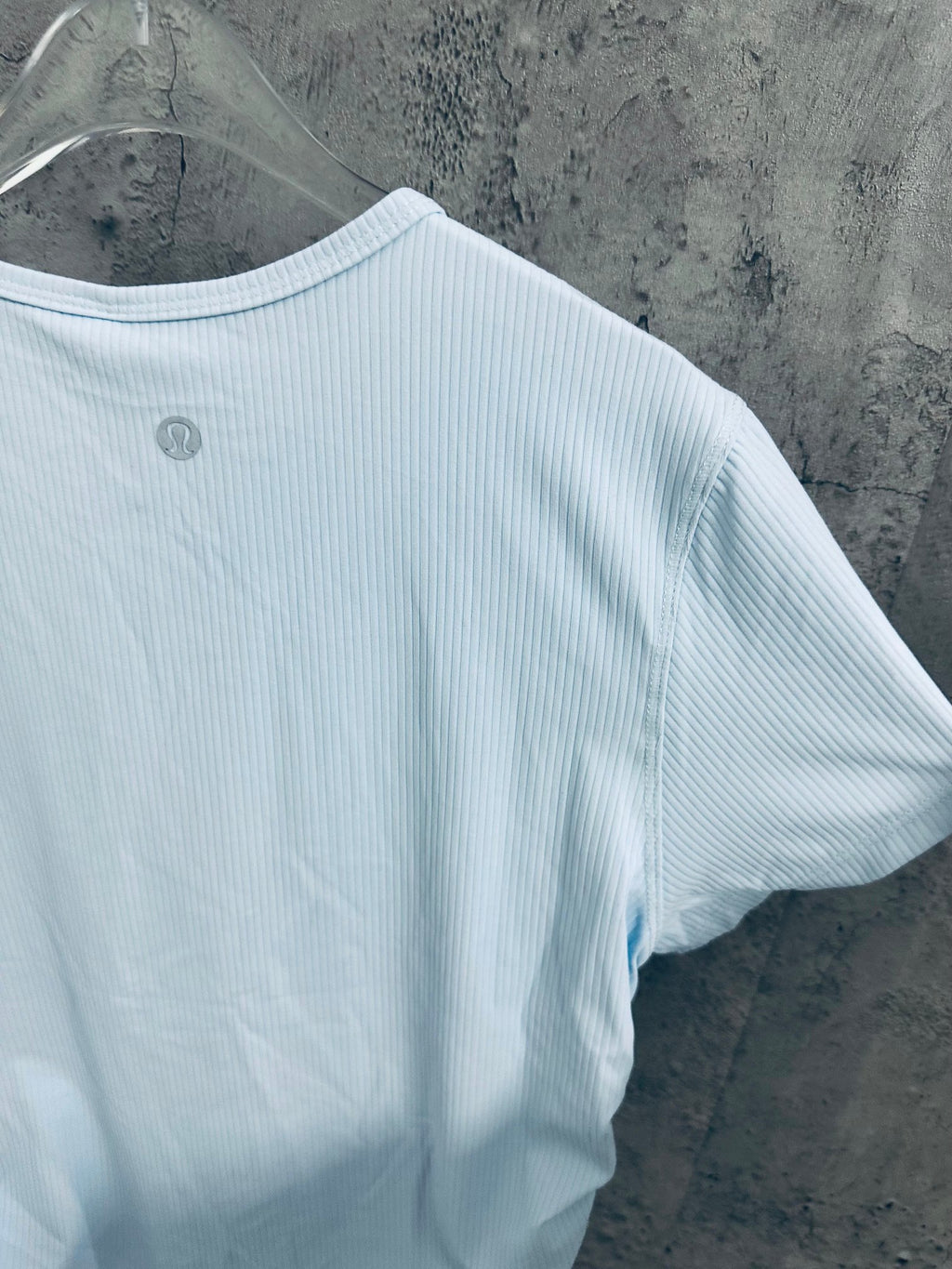 Light blue T-shirt side view with short sleeves and ribbed fabric