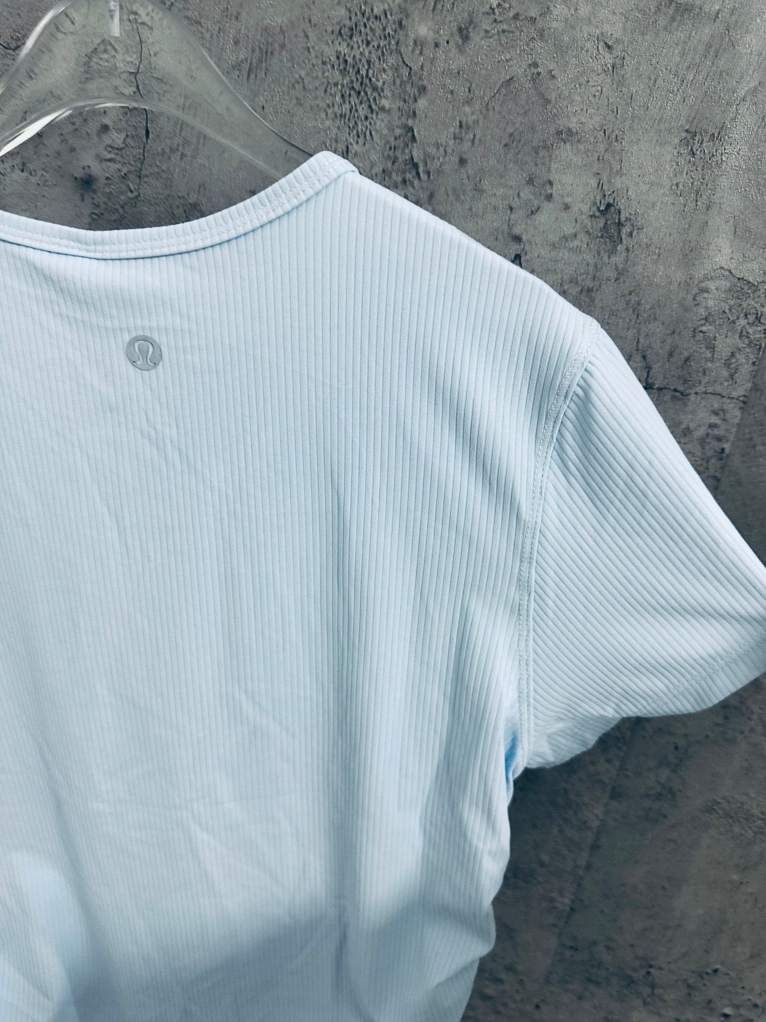 Light blue T-shirt side view with short sleeves and ribbed fabric