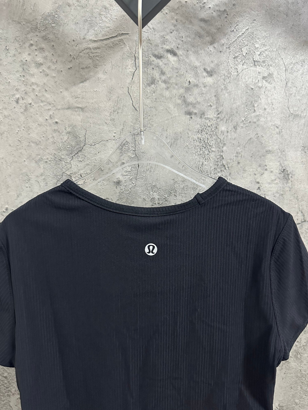 Dark crewneck T-shirt back with small circular logo