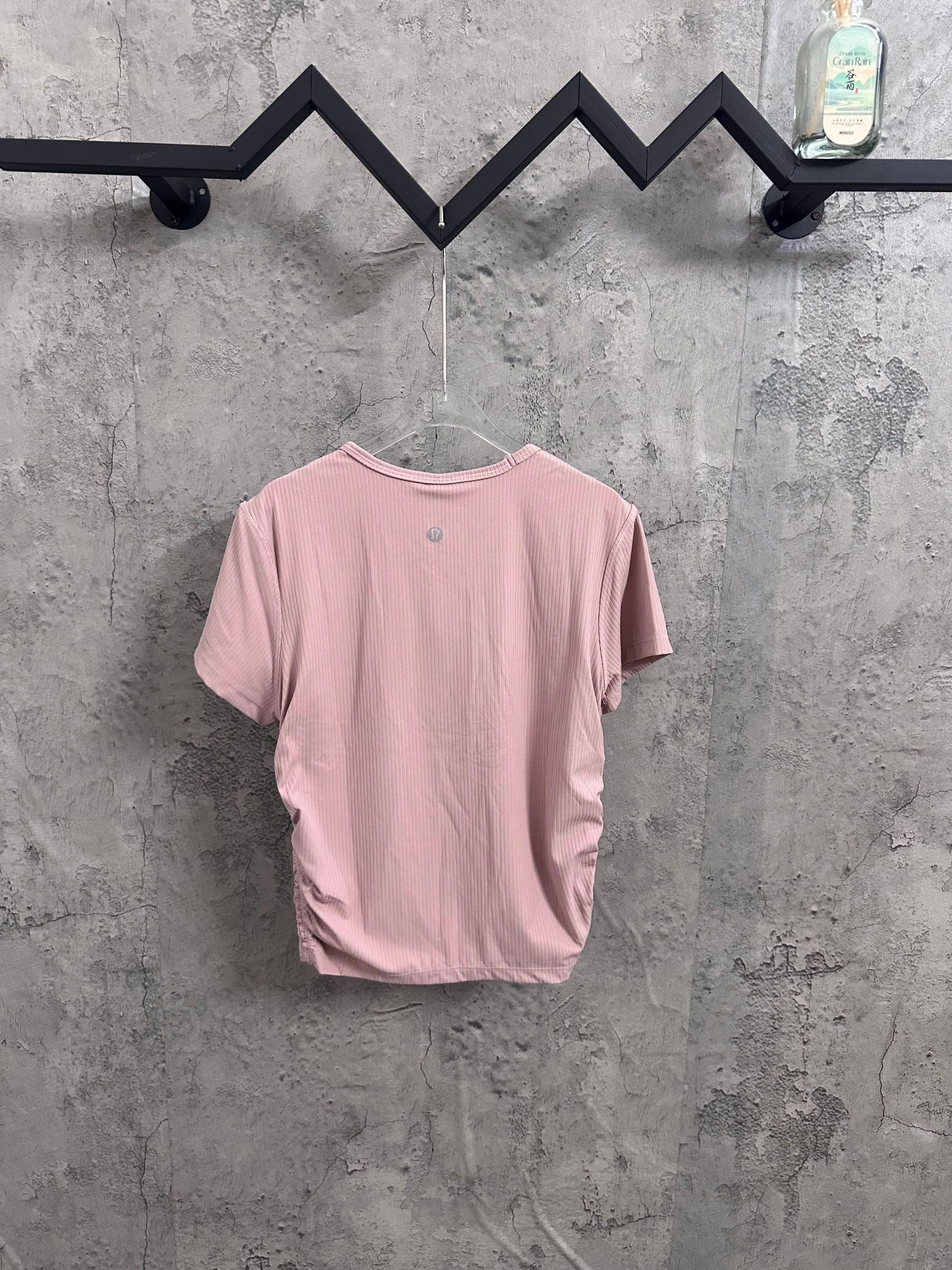 Light pink ribbed crew-neck T-shirt back view on hanger
