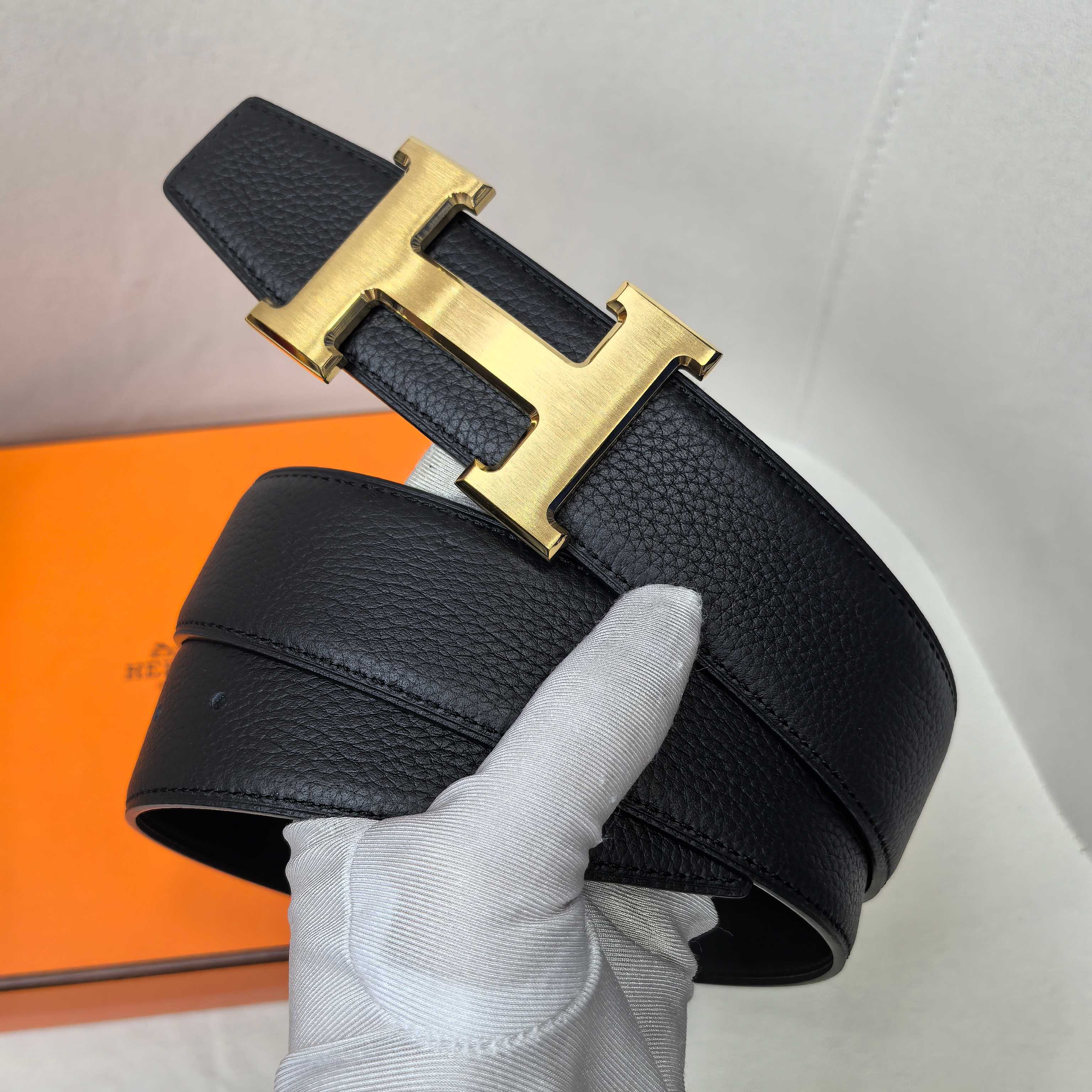 Hermes belt, black textured leather, gold-tone H buckle centerpiece