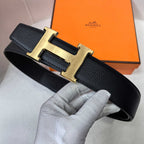 Hermes belt with black strap and gold-tone H buckle, full view