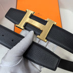 Hermes belt close-up, black textured leather with gold-tone H buckle