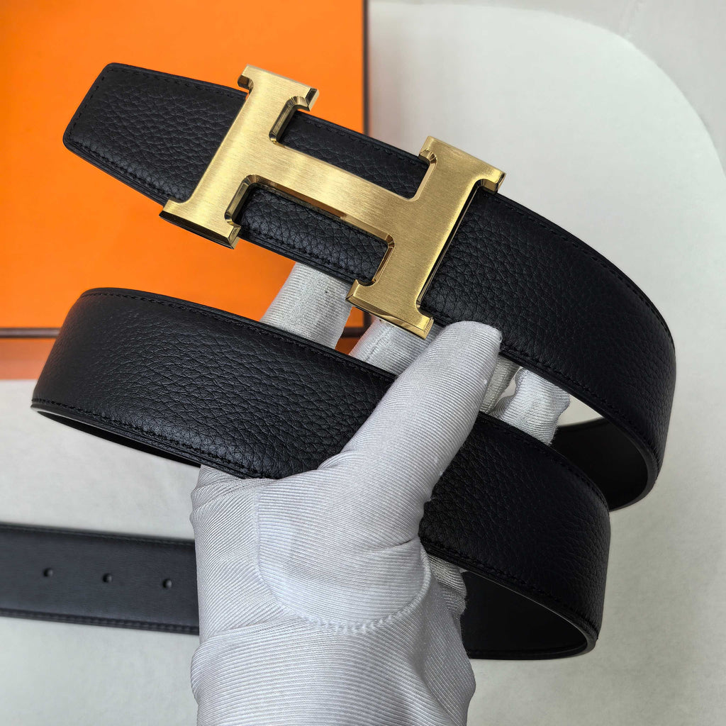 Hermes belt, black leather strap with gold-tone H buckle on top