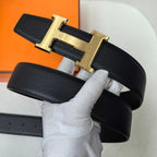 Hermes belt, black leather strap with gold-tone H buckle on top