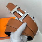 Hermes leather belt with silver-tone buckle and tan-brown strap, contrast stitching