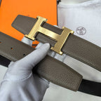 Hermes belt dark brown textured leather with gold H buckle, front view