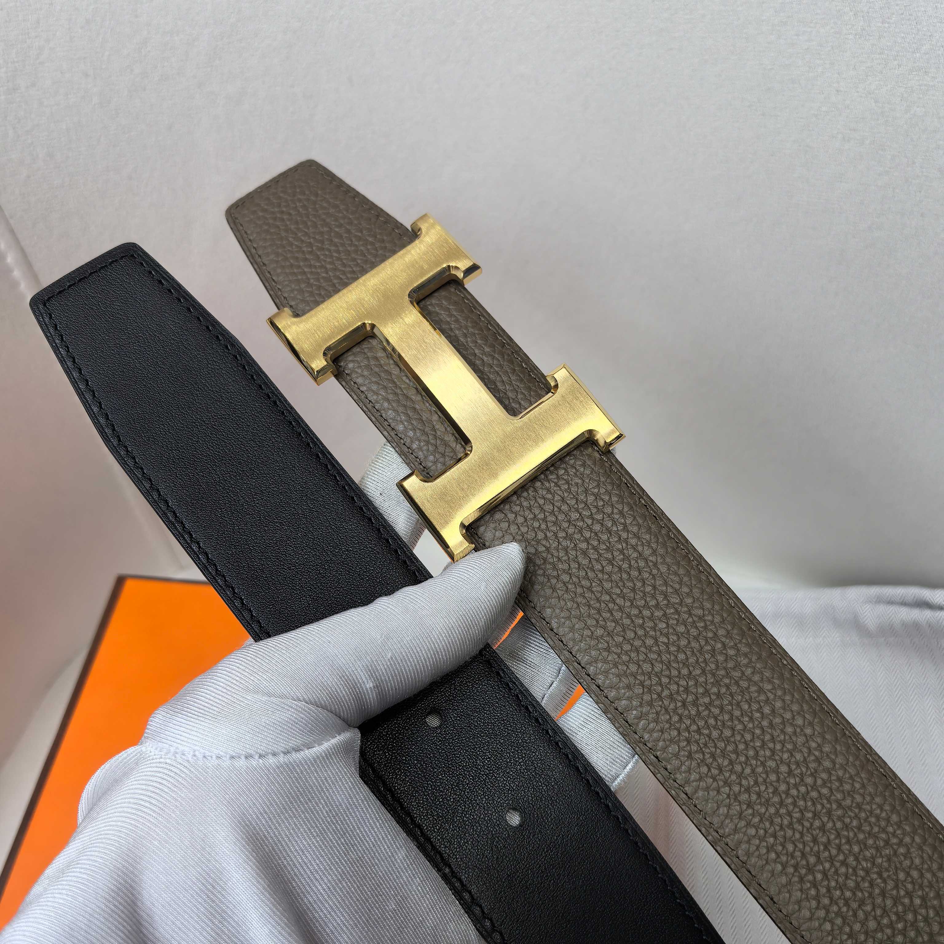 Hermes belt in dark leather with gold H buckle and strap edge detail