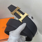 Hermes belt with textured dark leather and gold-tone H buckle, clasp detail