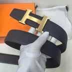 Hermes belt close-up: dark leather strap with gold-tone H buckle centered